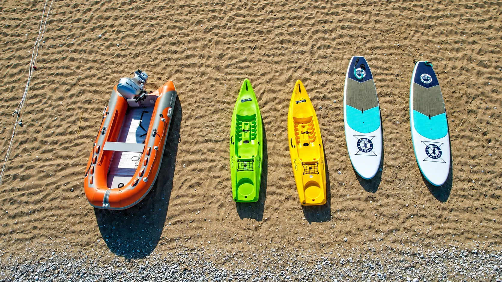 Riptide boat, canoe, and SUP boards set on Afandou Beach